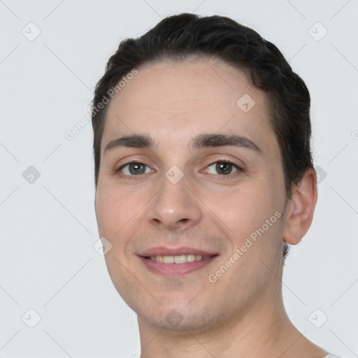 Joyful white young-adult male with short  black hair and brown eyes