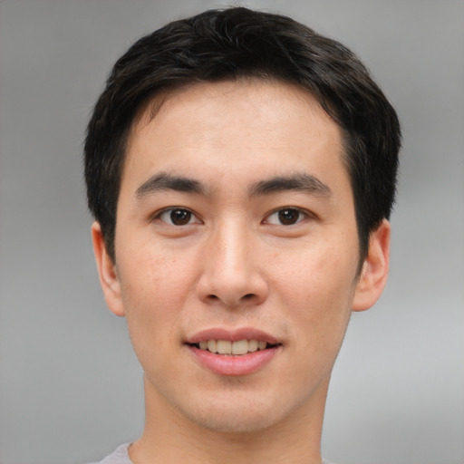 Joyful asian young-adult male with short  brown hair and brown eyes