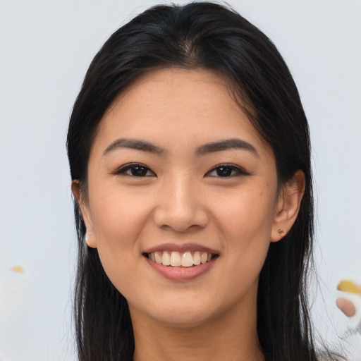 Joyful asian young-adult female with long  brown hair and brown eyes