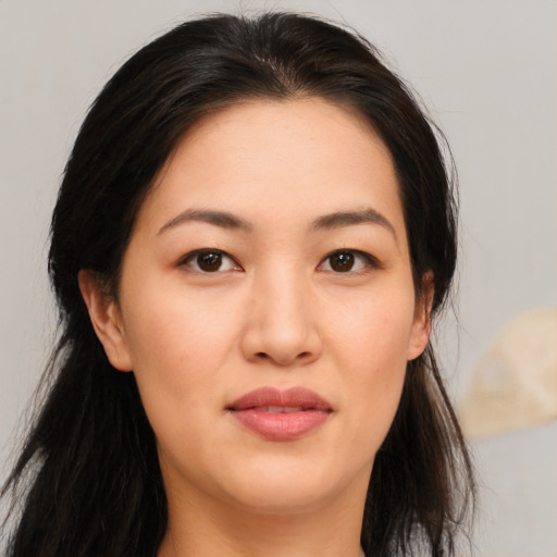 Joyful asian young-adult female with long  brown hair and brown eyes