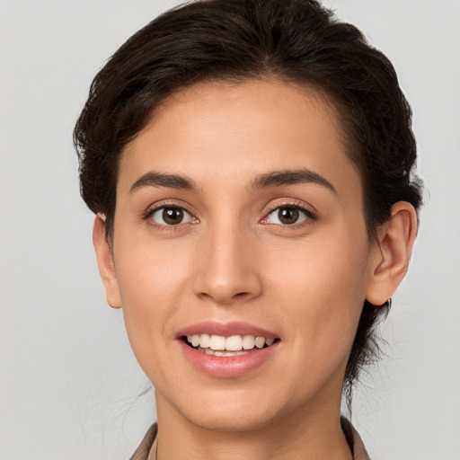 Joyful white young-adult female with long  brown hair and brown eyes