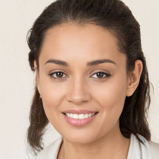 Joyful white young-adult female with long  brown hair and brown eyes