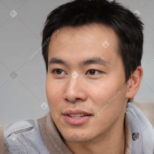 Joyful asian young-adult male with short  brown hair and brown eyes