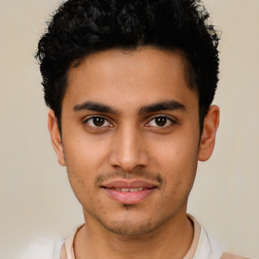 Joyful latino young-adult male with short  brown hair and brown eyes