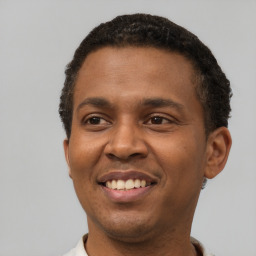 Joyful latino young-adult male with short  brown hair and brown eyes