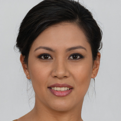 Joyful asian young-adult female with medium  brown hair and brown eyes