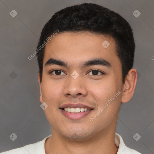 Joyful latino young-adult male with short  black hair and brown eyes