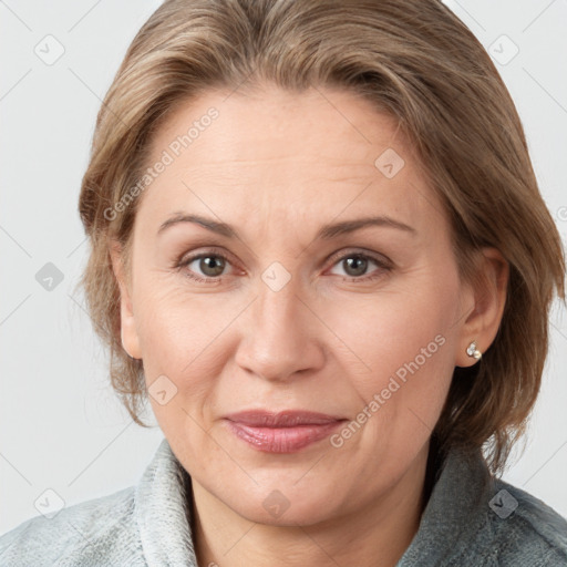 Joyful white adult female with medium  brown hair and blue eyes