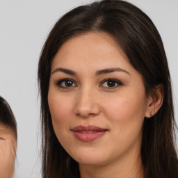 Joyful white young-adult female with long  brown hair and brown eyes