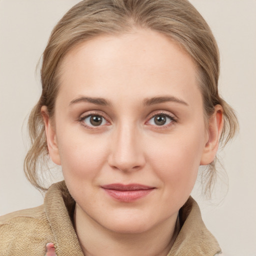 Joyful white young-adult female with medium  brown hair and blue eyes