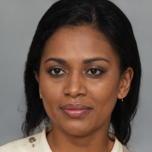 Joyful black young-adult female with medium  brown hair and brown eyes