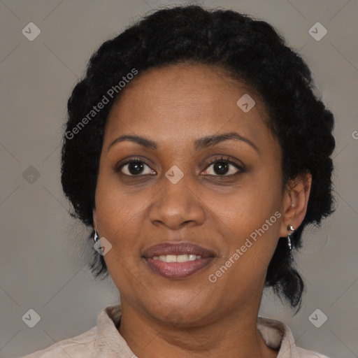 Joyful black adult female with short  brown hair and brown eyes