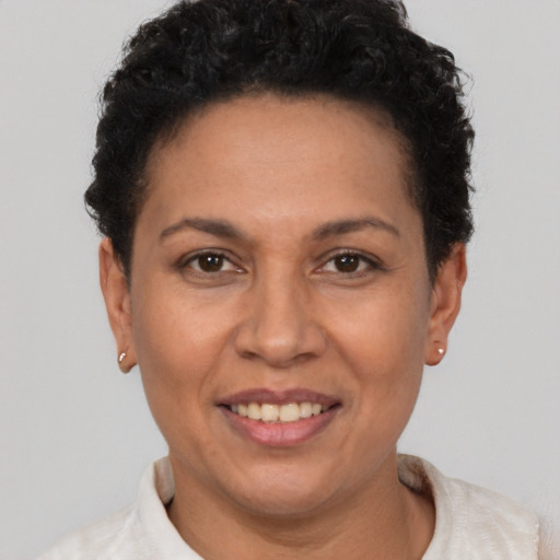 Joyful latino adult female with short  brown hair and brown eyes