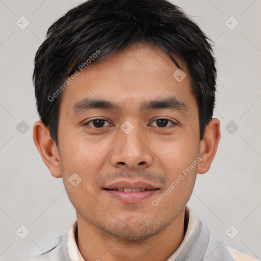 Joyful asian young-adult male with short  black hair and brown eyes