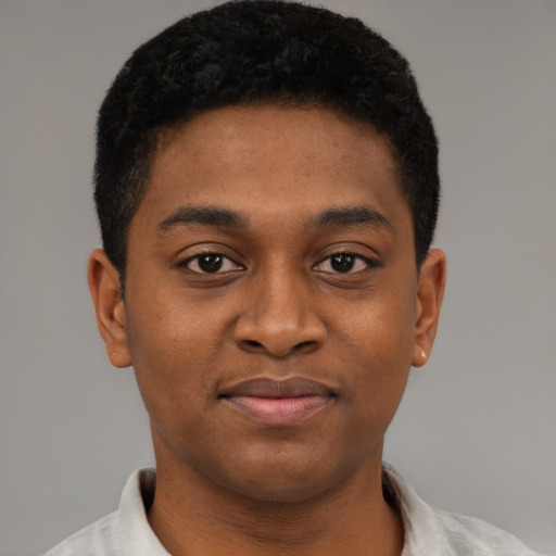 Joyful black young-adult male with short  brown hair and brown eyes