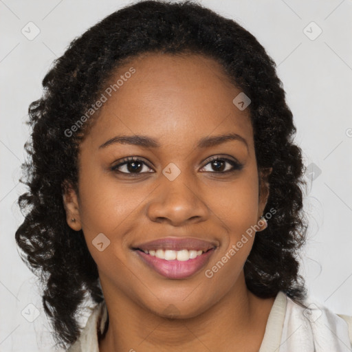 Joyful black young-adult female with long  brown hair and brown eyes