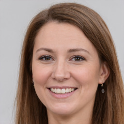 Joyful white young-adult female with long  brown hair and grey eyes