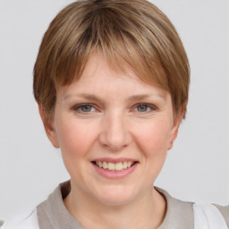 Joyful white young-adult female with short  brown hair and grey eyes