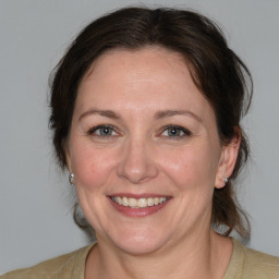 Joyful white adult female with medium  brown hair and brown eyes