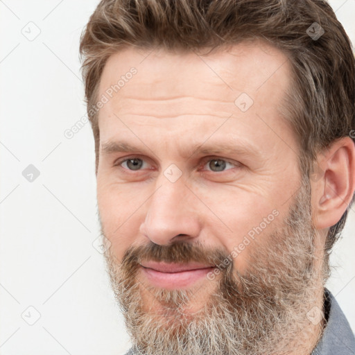 Joyful white adult male with short  brown hair and grey eyes