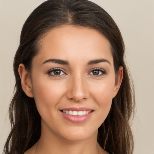 Joyful white young-adult female with long  brown hair and brown eyes