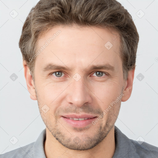 Joyful white adult male with short  brown hair and grey eyes