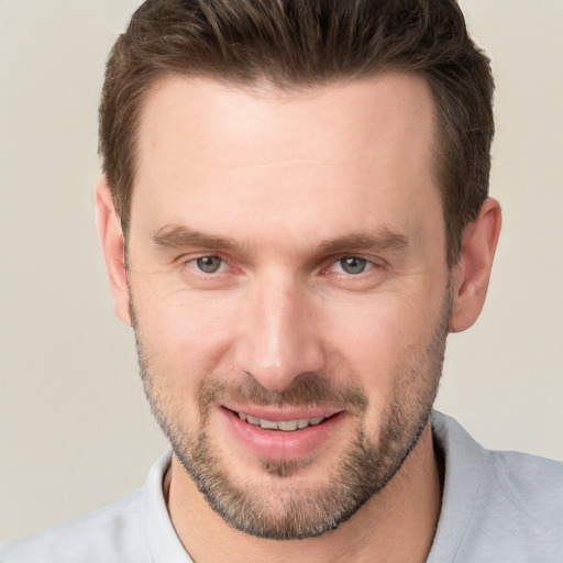 Joyful white adult male with short  brown hair and brown eyes