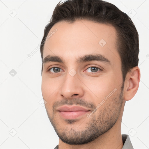 Joyful white young-adult male with short  brown hair and brown eyes