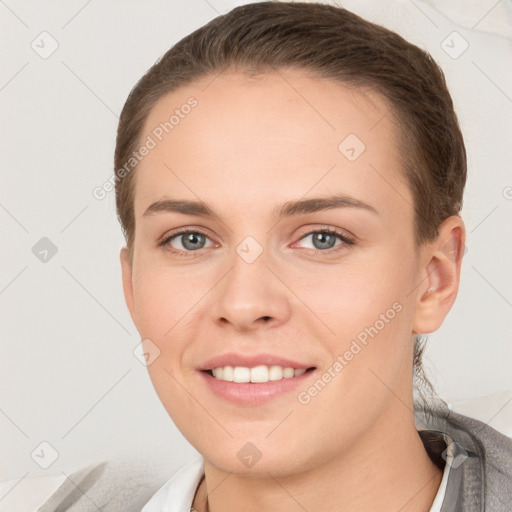 Joyful white young-adult female with short  brown hair and grey eyes