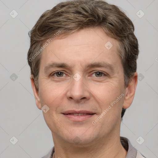 Joyful white adult male with short  brown hair and grey eyes