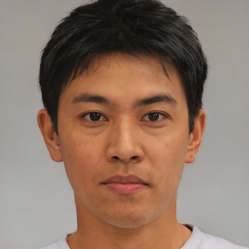 Joyful asian young-adult male with short  brown hair and brown eyes