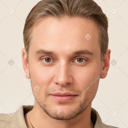 Joyful white young-adult male with short  brown hair and grey eyes