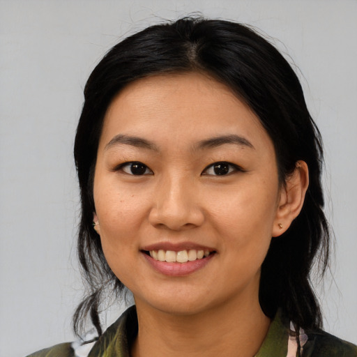 Joyful asian young-adult female with medium  black hair and brown eyes