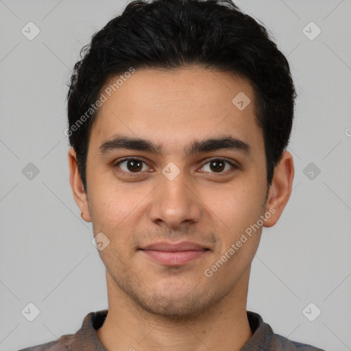 Joyful white young-adult male with short  black hair and brown eyes