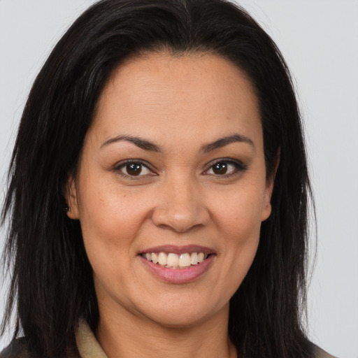 Joyful latino young-adult female with long  brown hair and brown eyes