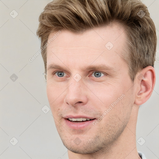 Joyful white adult male with short  brown hair and grey eyes