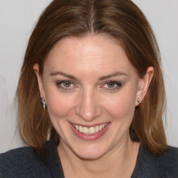 Joyful white adult female with medium  brown hair and brown eyes