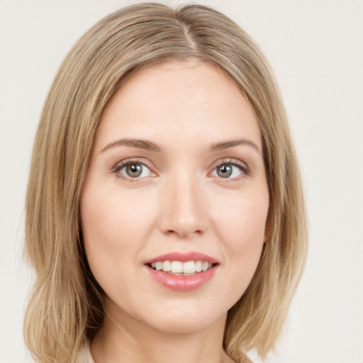 Joyful white young-adult female with medium  brown hair and green eyes