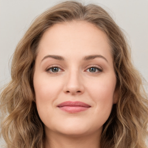 Joyful white young-adult female with long  brown hair and green eyes