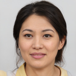 Joyful asian young-adult female with medium  brown hair and brown eyes