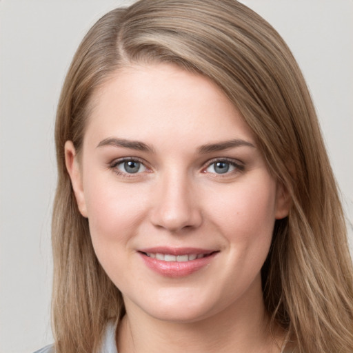 Joyful white young-adult female with long  brown hair and grey eyes