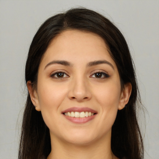 Joyful white young-adult female with long  brown hair and brown eyes