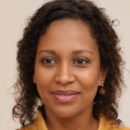 Joyful black young-adult female with medium  brown hair and brown eyes