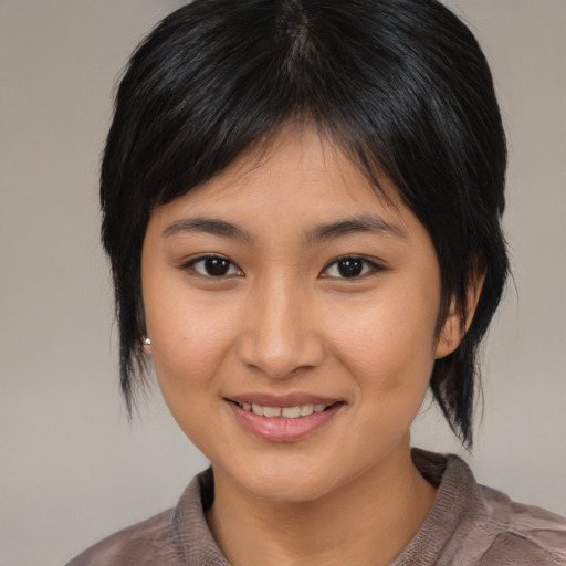 Joyful asian young-adult female with medium  brown hair and brown eyes