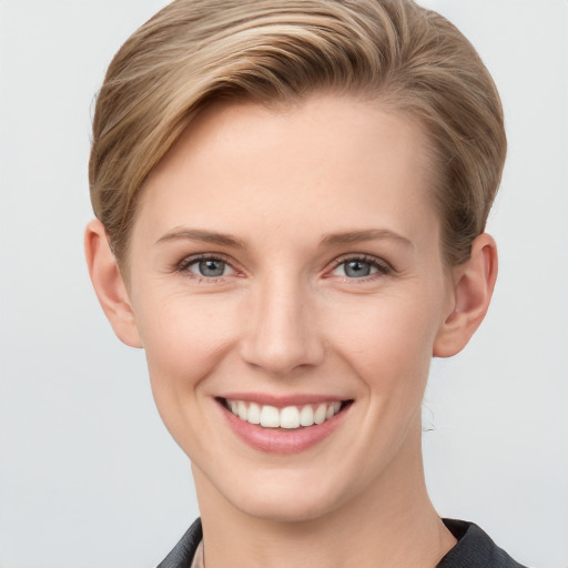 Joyful white young-adult female with short  brown hair and grey eyes