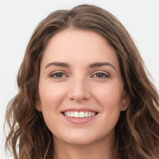 Joyful white young-adult female with long  brown hair and green eyes