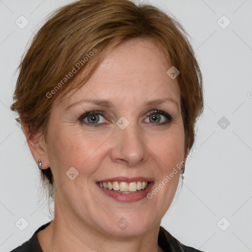 Joyful white adult female with medium  brown hair and blue eyes