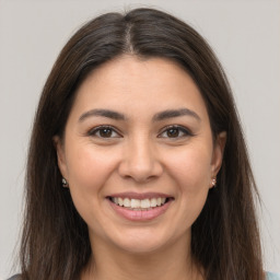 Joyful white young-adult female with long  brown hair and brown eyes