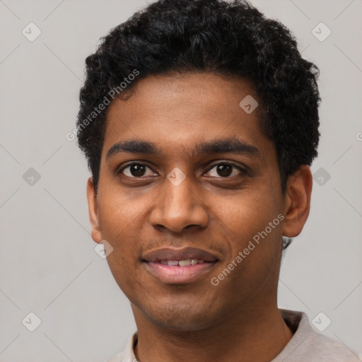 Joyful black young-adult male with short  black hair and brown eyes