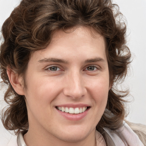 Joyful white young-adult female with medium  brown hair and blue eyes